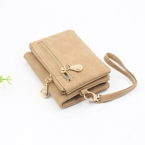 Detail view of khaki faux leather wallet with golden zipper and detachable wrist strap