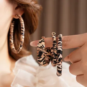 Retro leopard print hoop earrings for women featuring leather wrap and golden accents