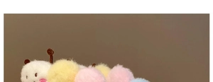 Detail of colorful plush caterpillar headband with soft rainbow pom-poms and antennae