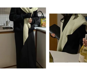 Detail of beige ribbed knit shawl collar accessory with thick vertical texture and drape