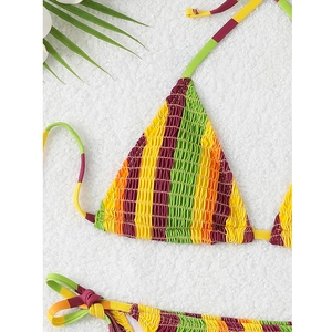 Detail of smocking texture on a colorful striped triangle bikini top with palm leaf