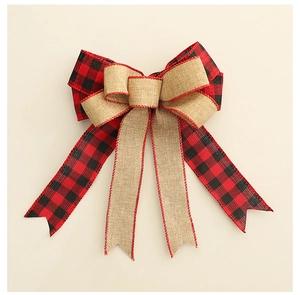 Detail of red and black plaid Christmas bow with rustic jute fabric and swallowtail ribbons