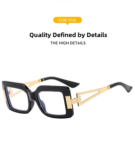 Detail view of bold black square frames with golden hollowed geometric metal temples