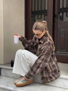 Women's casual oversized brown plaid flannel shirt jacket styled with white trousers