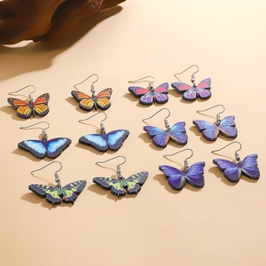 Set of six colorful butterfly drop earrings with detailed acrylic wings and silver hooks