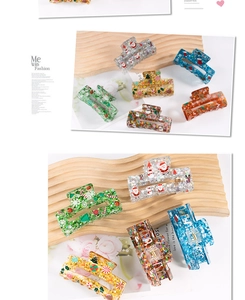 Macro detail of acrylic Christmas claw clips with glitter sequins and festive holiday patterns