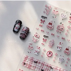 Winter Christmas nail stickers featuring snowmen, plaid patterns and bows on dark nails
