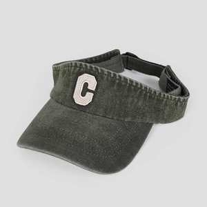 Detail of green washed denim sun visor showing C towel embroidery and fabric texture