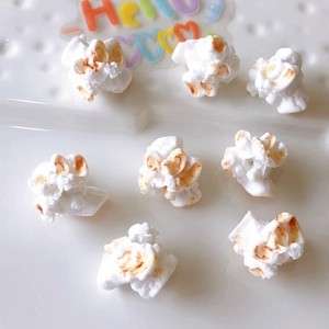 Macro shot of realistic white resin popcorn charms for DIY hair accessories and necklaces