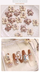 Detailed view of milk tea plush bear nail charms with white bows and sparkling rhinestones
