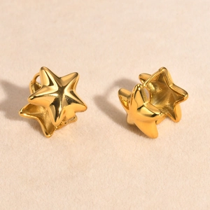 Close-up of golden star hoop earrings showing the polished finish and clasp detail