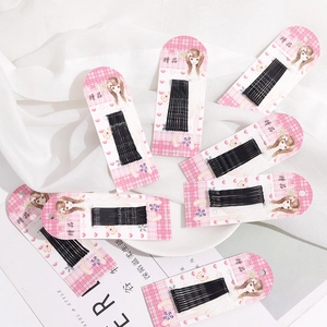 Detail view of 10 black metal wave hairpins neatly arranged on pink checkered card