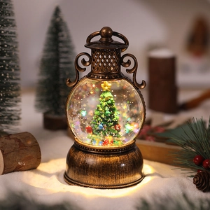 Close-up of vintage bronze Christmas lantern with a glowing tree inside and glitter