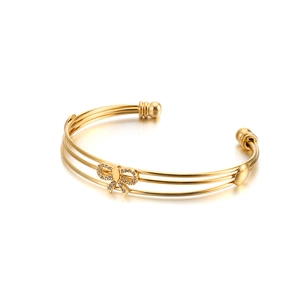 Bracelet jon jonc doré multicouche orné d'un papillon étincelant serti de strass