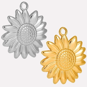 Close-up of sun flower pendants in gold and silver finish for DIY jewelry making