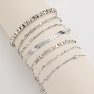 Detail view of silver multi-layer metal blade chains and beaded bracelets on display stand