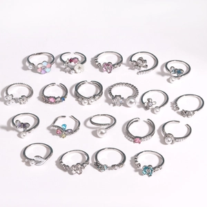 Detailed collection of silver rings with zircon butterflies, flowers and pearls