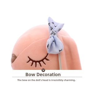 Detailed macro shot of a plush rabbit doll with a blue bow tie and embroidered eyes