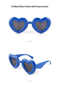 Macro view of blue heart-shaped sunglasses with gray lenses and glossy plastic frames