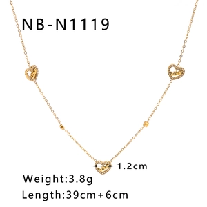 Detail of 18K gold heart necklace featuring LOVE engraving and small diamond accents