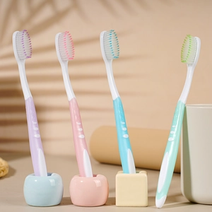 Premium soft bristle toothbrushes in purple, pink, blue, and green for gum care