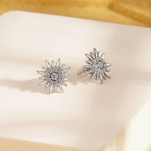 Elegant vintage starburst earrings in polished silver with shimmering crystals