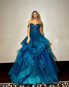 Detail of teal off-shoulder ball gown with sequined floral bodice and layered tulle skirt