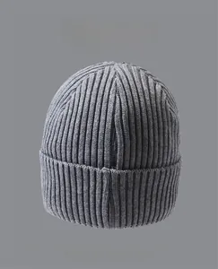 Detail shot of grey ribbed knit beanie showing high-quality fabric texture and multiple colors