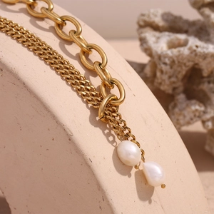 Detail of 18K gold plated double Cuban chain with elegant drop-shaped freshwater pearls