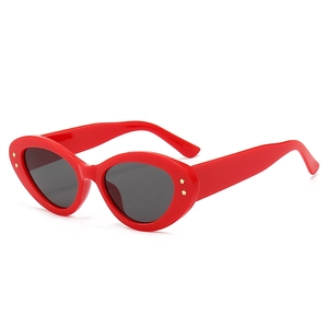 Chic red oval cat eye sunglasses with gold star rivets and dark lenses for women