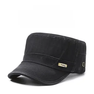 Detail of washed black cotton cadet hat featuring a metal logo plate and breathable eyelets