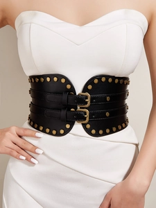Detail of a black wide corset belt featuring gold metal studs and double vintage buckles