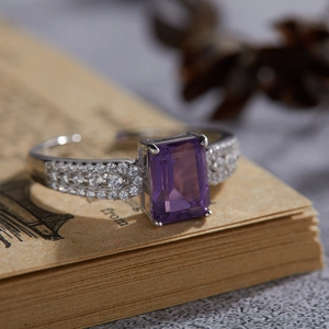 S925 sterling silver ring with square purple amethyst on a vintage book page