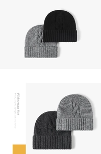 Close-up of thick cable knit patterns on stylish winter beanies in grey and black