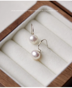 Detail of 8-9mm natural freshwater pearls with S925 sterling silver hooks on white velvet