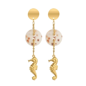 Golden sea horse earrings with pearl accents and delicate chains on a clean background