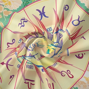 Macro shot of sun and moon tapestry fabric texture with zodiac symbols and astrological icons