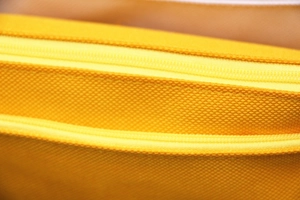 Close-up of bright yellow honeycomb texture fabric and matching zipper on stationery bag