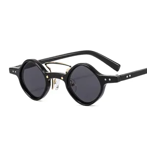 Black avant-garde punk sunglasses with asymmetrical geometric lenses and gold bridge