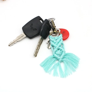Detail of turquoise macrame cotton rope keychain with tassel and metal clasp
