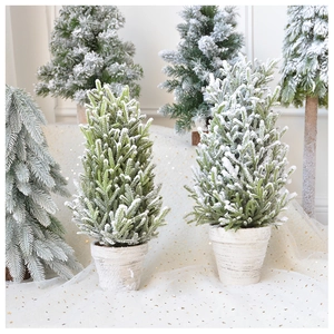 Detail of flocked mini Christmas trees in assorted sizes with vintage white pot bases