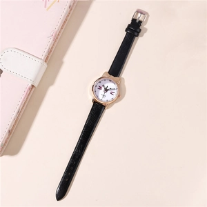 Detail of rose gold cat ear watch case with cartoon face and black leather strap