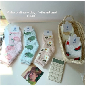 Detailed view of thick coral fleece winter socks with cute fruit and floral patterns