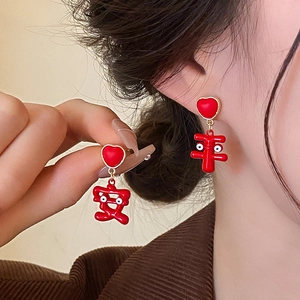 Detail of red heart stud earrings with Chinese Pingan character tassel in gold finish