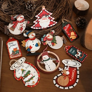 Set of rustic Christmas wood ornaments with Santa and Snowman designs on wood surface
