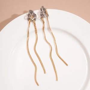 Detail shot of long snake chain fringe earrings in gold and silver metallic tones