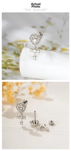 Detail view of silver heart and cross stud earring with zircon inlay and screw back