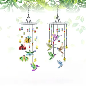 Detail of DIY diamond painting wind chimes with colorful beads and small metal bells