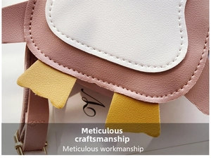 Close-up of pink penguin kids bag showing lychee pattern PU leather and stitching detail