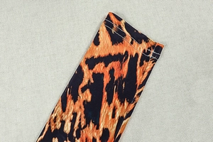 Close-up of leopard print dress sleeve showing precise double-needle stitching quality
